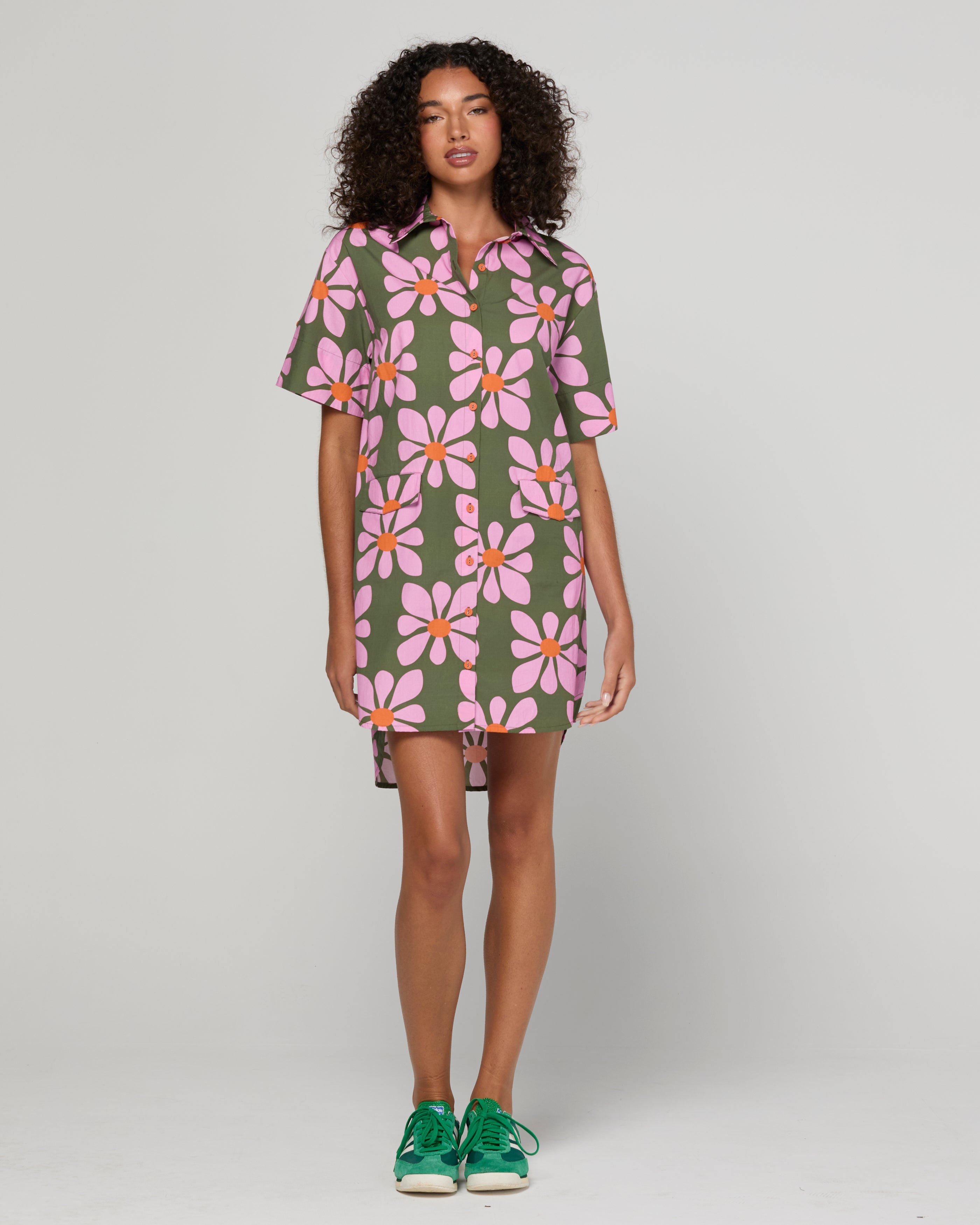 Woman wearing a floral dress with a plain background