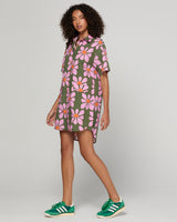 Woman wearing a green and pink floral dress 
