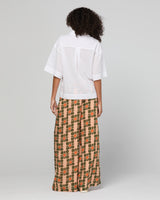 Lady wearing a white shirt and patterned pants
