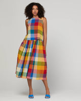 Woman wearing a colorful plaid top and skirt